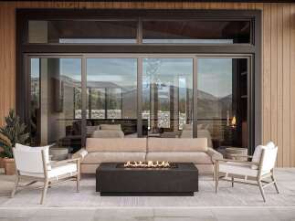 Experience luxurious outdoor living with this stunning patio setup, featuring a modern gas fire pit as the centerpiece.