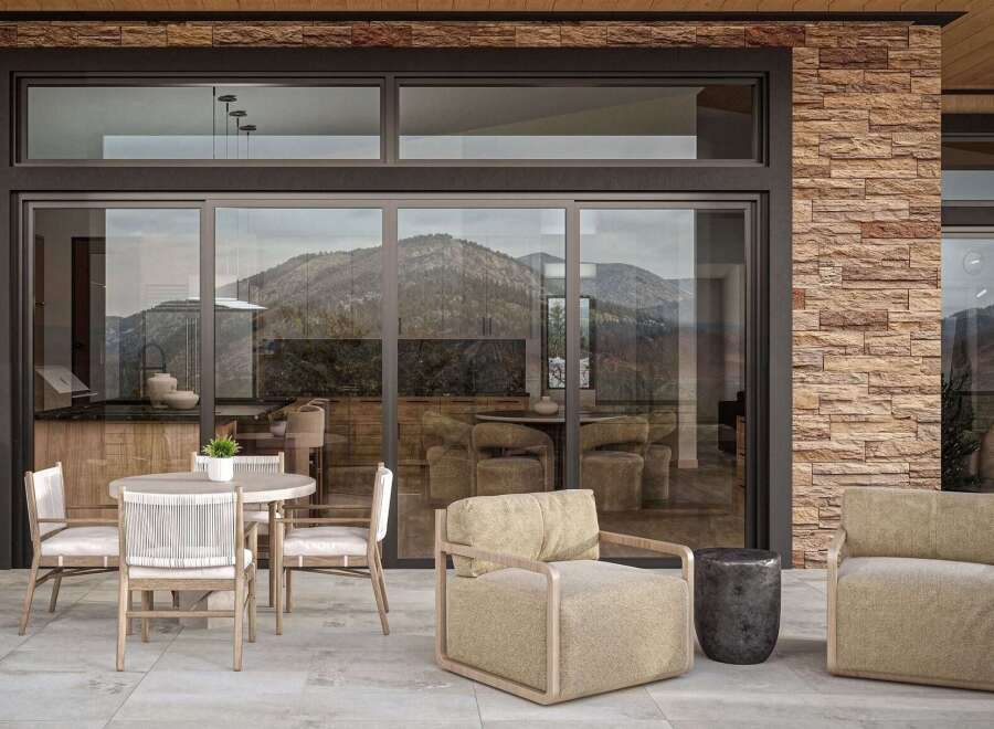 Experience seamless indoor-outdoor living with this stunning patio featuring a modern dining set and comfortable lounge chairs.