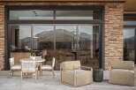 Experience seamless indoor-outdoor living with this stunning patio featuring a modern dining set and comfortable lounge chairs.