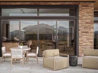 Experience seamless indoor-outdoor living with this stunning patio featuring a modern dining set and comfortable lounge chairs.