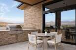 Experience luxury outdoor living with this stunning patio featuring a built-in grill and spacious countertop.