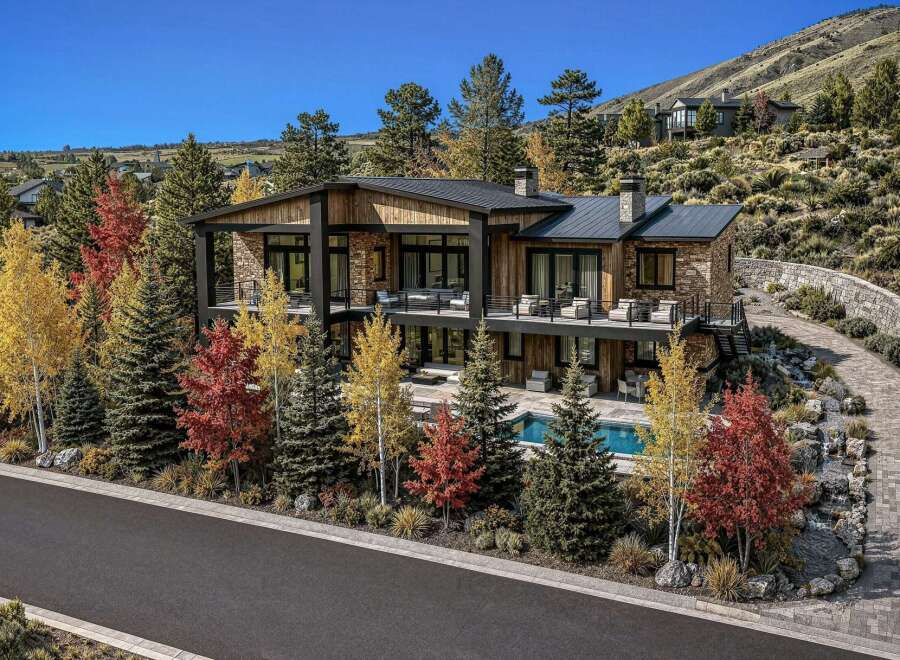 Experience luxury mountain living in this stunning contemporary home, nestled amidst vibrant autumn foliage.