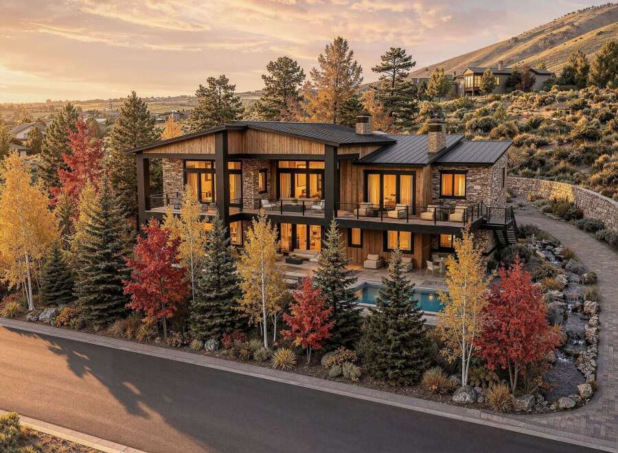 Experience luxury living in this stunning modern home, nestled amidst vibrant autumn foliage and rolling hills.