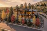 Experience luxury living in this stunning modern home, nestled amidst vibrant autumn foliage and rolling hills.