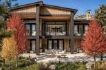 Experience luxury living in this modern mountain home, featuring a striking blend of natural wood and stone accents.
