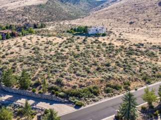 Discover this stunning estate nestled in a serene, arid landscape with panoramic views of rolling hills.