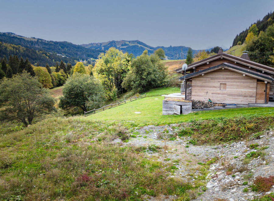 Experience the charm of this rustic wooden chalet nestled in a picturesque mountain landscape.