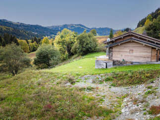 Experience the charm of this rustic wooden chalet nestled in a picturesque mountain landscape.