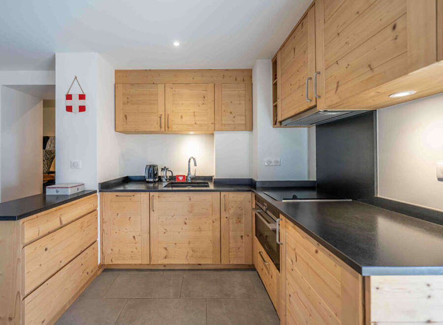 This charming kitchen boasts beautiful natural wood cabinetry, offering a warm and inviting atmosphere.