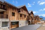 Discover modern alpine living in this stunning new construction featuring a harmonious blend of natural wood and stone.