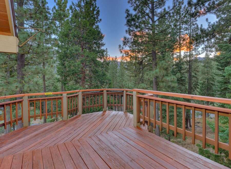 Step out onto this expansive wooden deck, perfect for enjoying the serene mountain views.