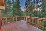 Step out onto this expansive wooden deck, perfect for enjoying the serene mountain views.