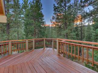 Step out onto this expansive wooden deck, perfect for enjoying the serene mountain views.