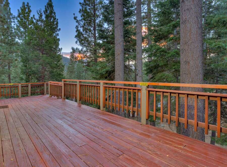 Step onto this expansive wooden deck, perfect for enjoying the serene mountain views.
