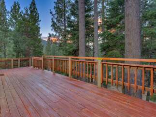 Step onto this expansive wooden deck, perfect for enjoying the serene mountain views.