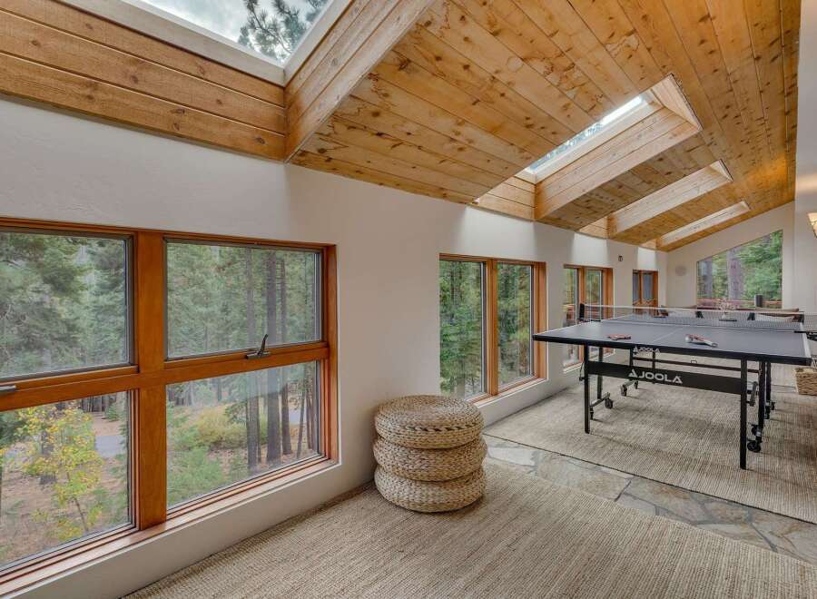 Enjoy indoor recreation in this spacious game room featuring a professional JOOLA ping pong table.