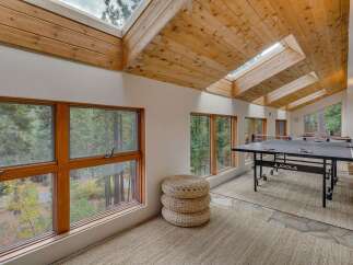 Enjoy indoor recreation in this spacious game room featuring a professional JOOLA ping pong table.