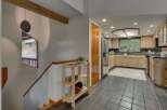 Step into a charming entryway with a unique stone pendant light and a wooden staircase leading to the upper level.