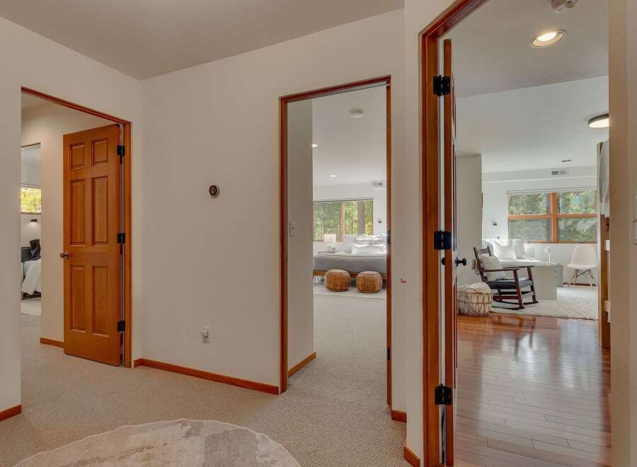 Step into a beautifully appointed hallway that offers glimpses into multiple inviting spaces.