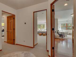 Step into a beautifully appointed hallway that offers glimpses into multiple inviting spaces.