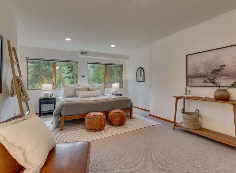 Experience serene living in this beautifully appointed bedroom, featuring a comfortable king-sized bed dressed in neutral linens and accented with plush pillows.