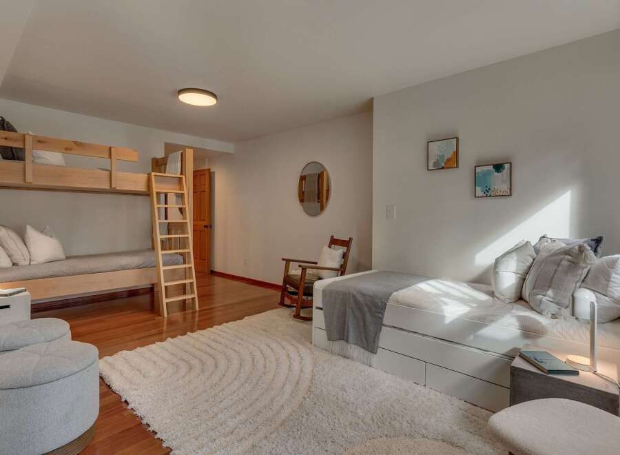 This spacious bedroom comfortably sleeps multiple guests with its twin-over-twin bunk bed and a pull-out trundle bed.