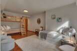 This spacious bedroom comfortably sleeps multiple guests with its twin-over-twin bunk bed and a pull-out trundle bed.