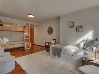 This spacious bedroom comfortably sleeps multiple guests with its twin-over-twin bunk bed and a pull-out trundle bed.