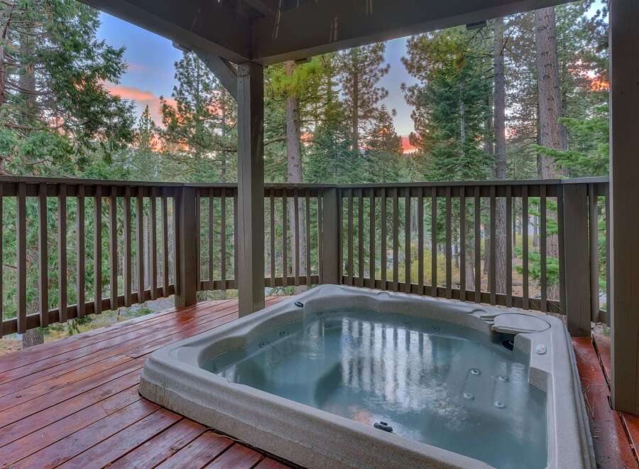 Enjoy a relaxing soak in this spacious hot tub, perfectly situated on a private wooden deck.
