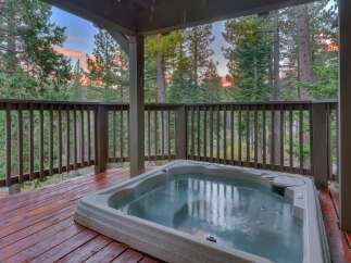 Enjoy a relaxing soak in this spacious hot tub, perfectly situated on a private wooden deck.
