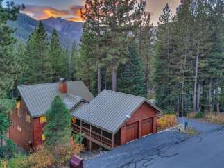 Nestled amidst towering pine trees, this charming wooden home offers a serene mountain retreat.
