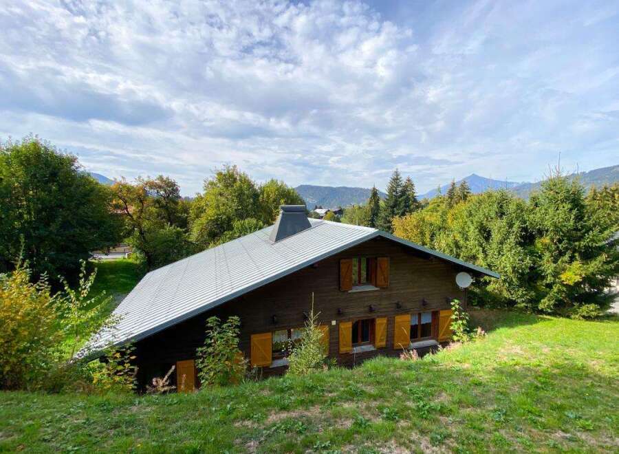 Nestled amidst lush greenery and rolling hills, this charming wooden chalet offers a serene mountain retreat.