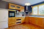 This charming kitchen features warm wooden cabinetry, providing ample storage and a classic aesthetic.