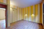 Step into a bright and cheerful room featuring playful yellow and cream striped walls, creating an inviting atmosphere.