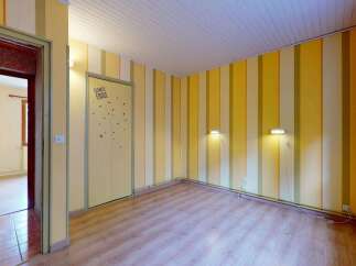 Step into a bright and cheerful room featuring playful yellow and cream striped walls, creating an inviting atmosphere.
