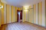 Step into a charming room featuring vibrant yellow and white striped wallpaper, creating a playful and inviting atmosphere.