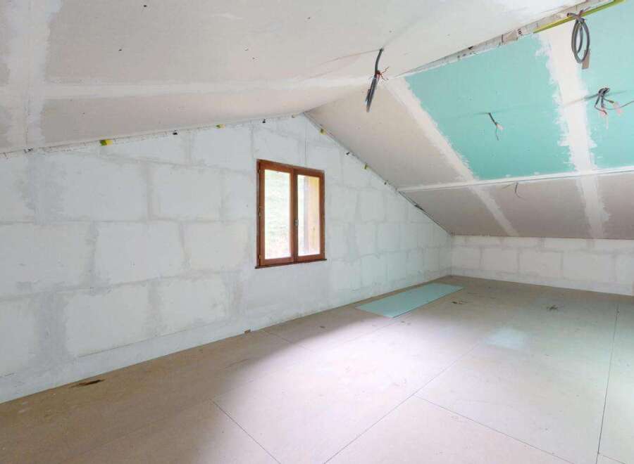This unfinished attic space presents a blank canvas for your dream renovation.