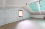 This unfinished attic space presents a blank canvas for your dream renovation.