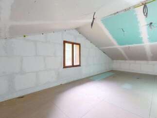 This unfinished attic space presents a blank canvas for your dream renovation.