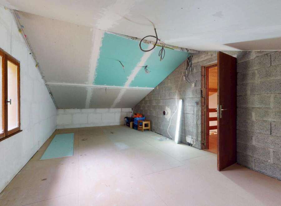This unfinished attic space presents a blank canvas for your dream home.