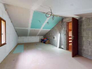 This unfinished attic space presents a blank canvas for your dream home.