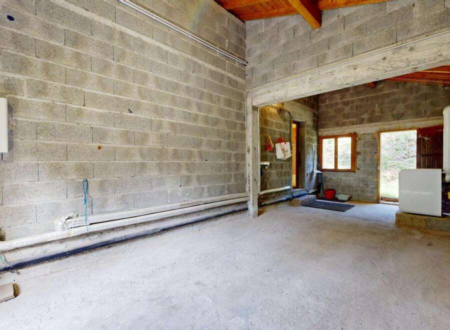 Discover this unfinished space, perfect for customization and ready to be transformed into your dream workshop or storage area.