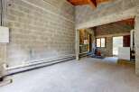 Discover this unfinished space, perfect for customization and ready to be transformed into your dream workshop or storage area.