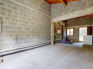 Discover this unfinished space, perfect for customization and ready to be transformed into your dream workshop or storage area.