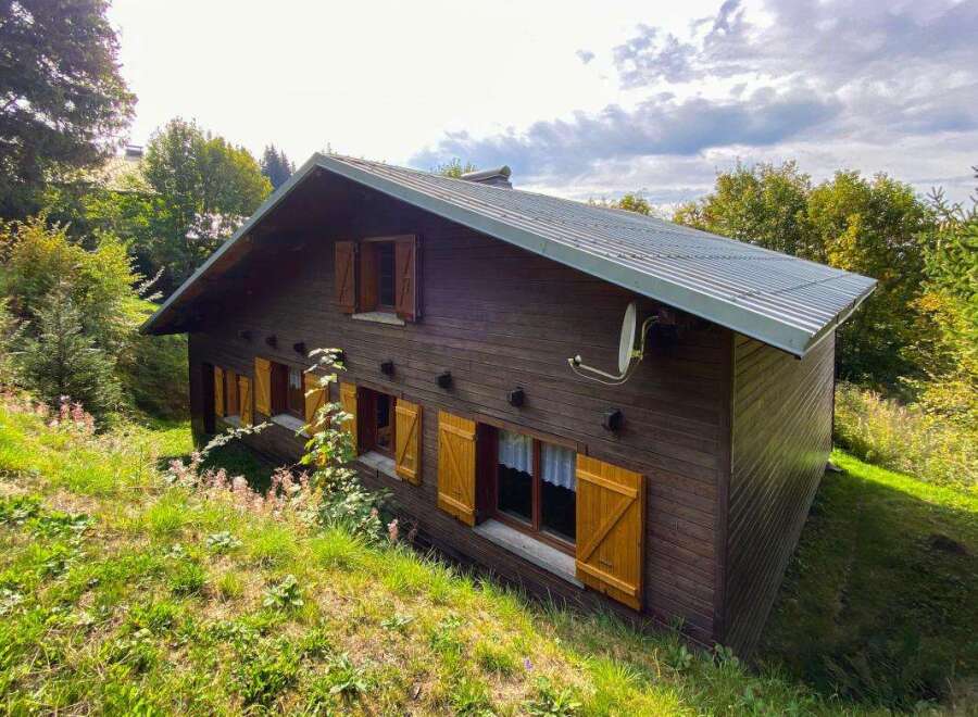 Nestled amidst lush greenery, this charming wooden chalet offers a serene mountain retreat.