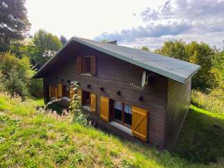 Nestled amidst lush greenery, this charming wooden chalet offers a serene mountain retreat.
