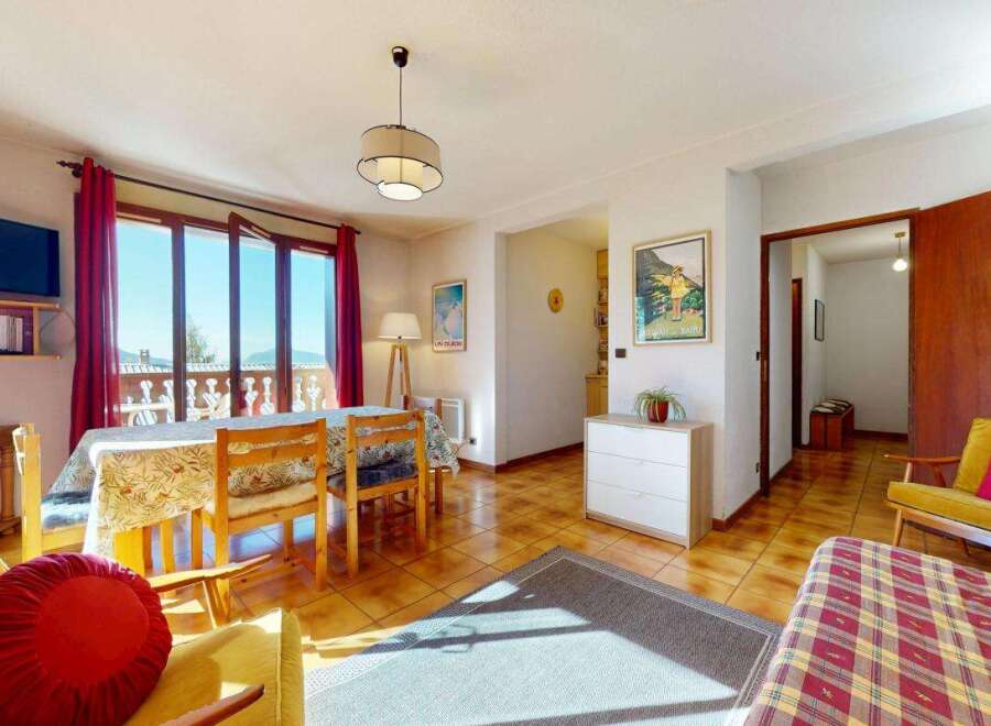 Enjoy a bright and airy living space with a dining area featuring a table and chairs, perfect for family meals.