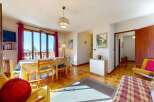 Enjoy a bright and airy living space with a dining area featuring a table and chairs, perfect for family meals.