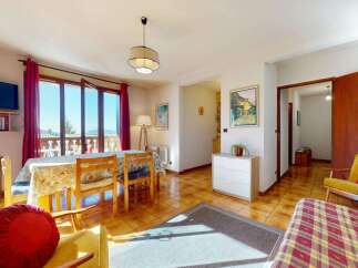 Enjoy a bright and airy living space with a dining area featuring a table and chairs, perfect for family meals.
