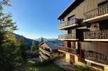 Experience breathtaking mountain views from the multiple balconies of this charming wooden chalet.